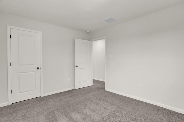 unfurnished bedroom with visible vents, baseboards, and carpet flooring