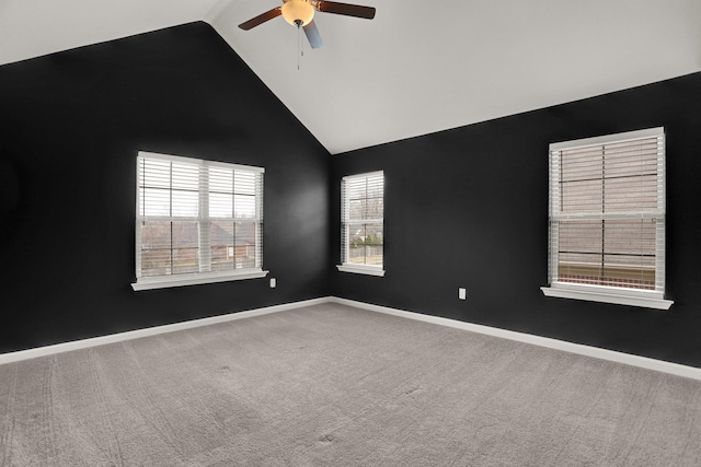 carpeted spare room with a ceiling fan, baseboards, and high vaulted ceiling