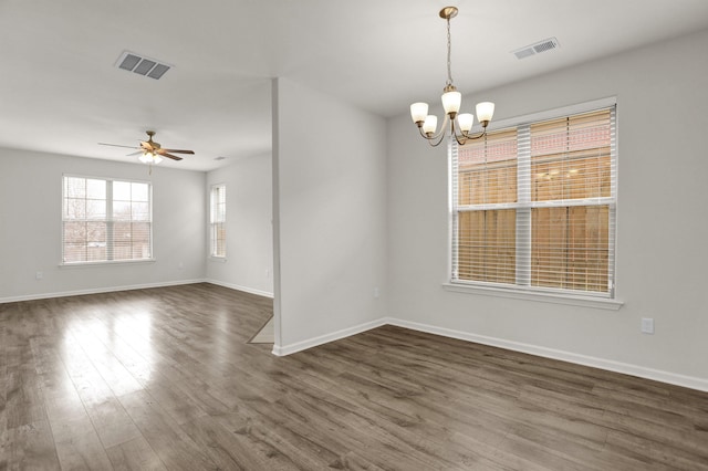 unfurnished room featuring visible vents, baseboards, and dark wood-type flooring