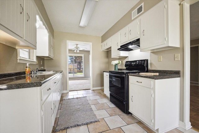 kitchen with dark countertops, visible vents, under cabinet range hood, black electric range oven, and white cabinetry