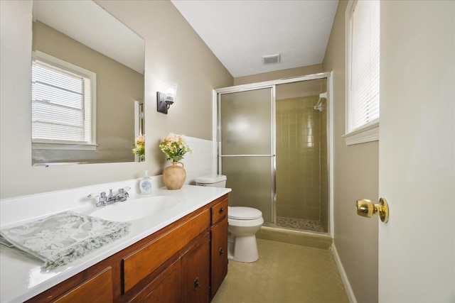 bathroom featuring visible vents, toilet, a healthy amount of sunlight, and a shower stall