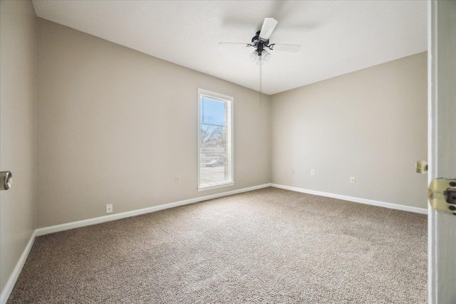 carpeted empty room with baseboards and a ceiling fan