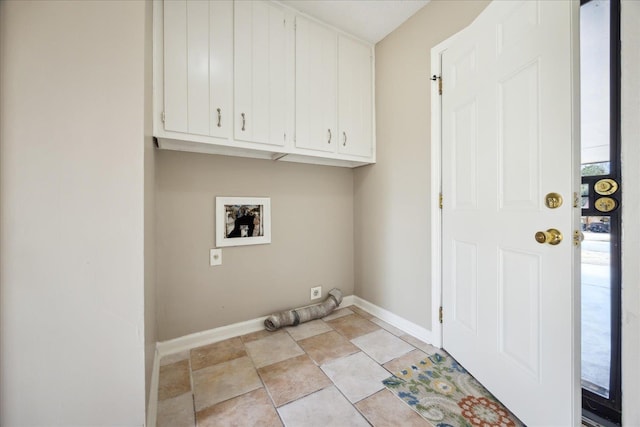 laundry room featuring washer hookup, cabinet space, and baseboards