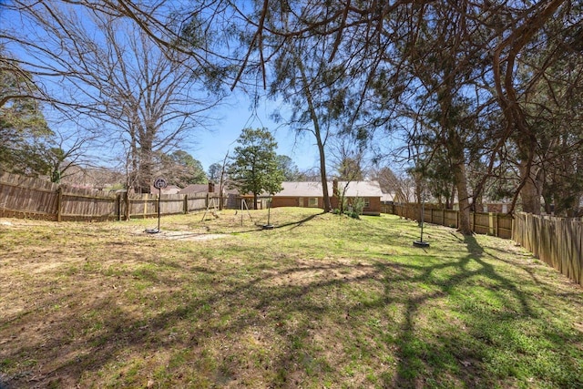 view of yard with a playground and a fenced backyard