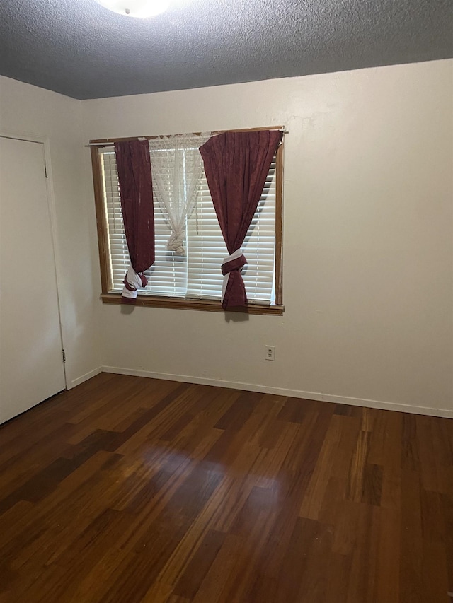 576 Monteagle Dr, Memphis, TN 38109 - spare room featuring wood finished floors, healthy amount of natural light, a textured ceiling, and baseboards