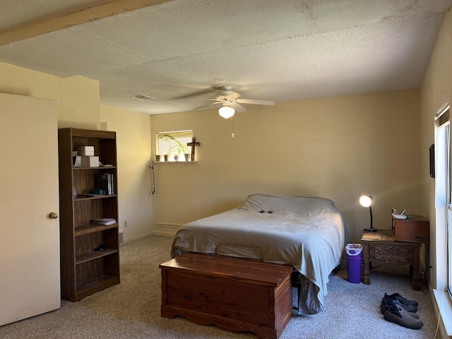 bedroom featuring baseboards, carpet floors, a textured ceiling, and ceiling fan
