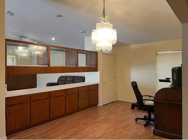 home office with baseboards, visible vents, light wood finished floors, and a chandelier