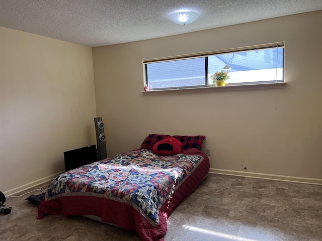 bedroom with carpet flooring, multiple windows, baseboards, and a textured ceiling