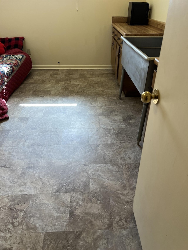 living room featuring stone finish flooring and baseboards
