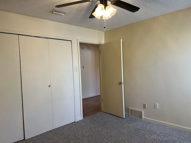 unfurnished bedroom featuring visible vents, carpet floors, and a textured ceiling