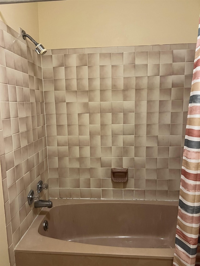 bathroom with shower / tub combo with curtain