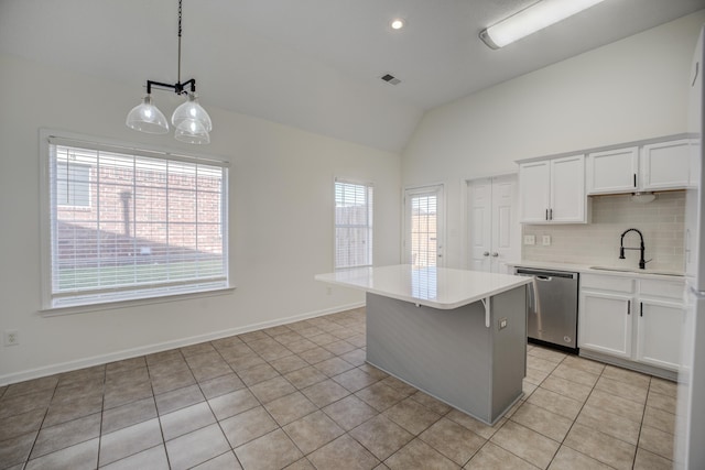 kitchen with visible vents, backsplash, light tile patterned flooring, light countertops, and dishwasher