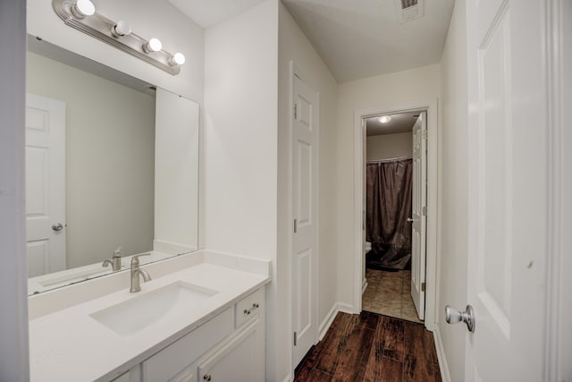 full bathroom featuring visible vents, wood finished floors, and vanity