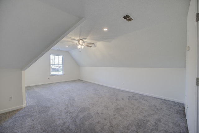 bonus room with visible vents, ceiling fan, carpet, baseboards, and vaulted ceiling