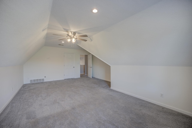 bonus room with visible vents, baseboards, vaulted ceiling, carpet flooring, and a ceiling fan