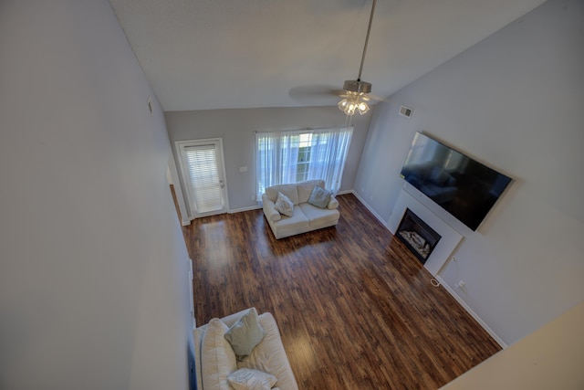 living area with visible vents, wood finished floors, baseboards, lofted ceiling, and ceiling fan