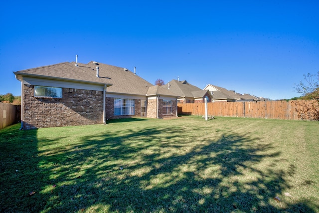 view of yard with a fenced backyard