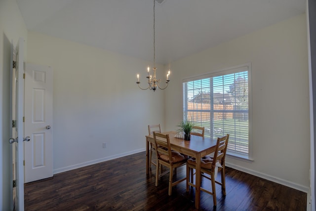 dining space featuring dark wood-style floors, baseboards, and an inviting chandelier