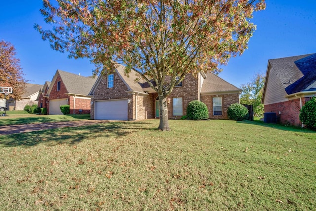 view of front of home featuring a front yard, central air condition unit, an attached garage, and brick siding