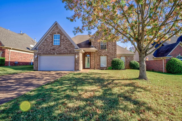 traditional-style home featuring a garage, a front yard, brick siding, and driveway