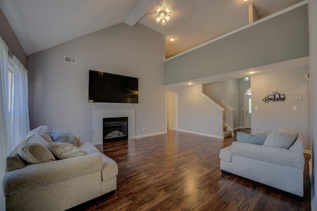 living area with stairway, dark wood-style floors, visible vents, high vaulted ceiling, and a fireplace