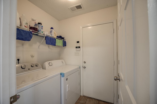 laundry area featuring visible vents, independent washer and dryer, a textured ceiling, tile patterned flooring, and laundry area