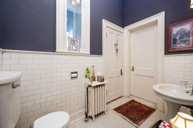 1860 Central Ave, Memphis, TN 38104 - bathroom with tile patterned flooring, toilet, radiator heating unit, wainscoting, and tile walls
