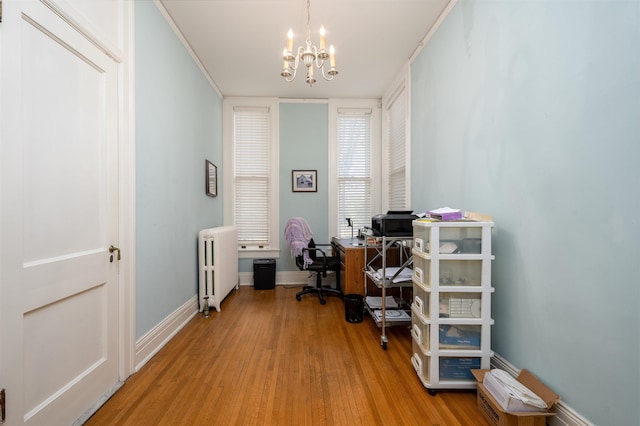 1860 Central Ave, Memphis, TN 38104 - office area with light wood-style flooring, baseboards, radiator, and a chandelier