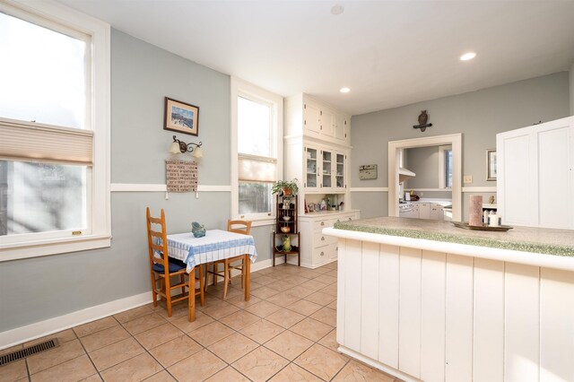 1860 Central Ave, Memphis, TN 38104 - kitchen with light tile patterned floors, visible vents, white cabinetry, and light countertops