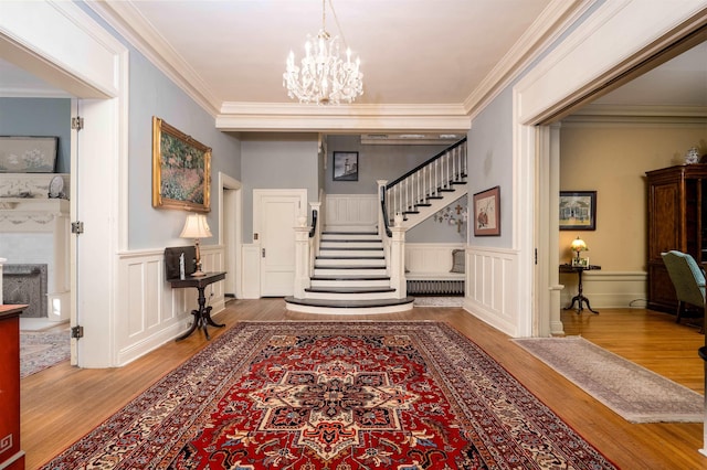 1860 Central Ave, Memphis, TN 38104 - foyer entrance with a notable chandelier, wood finished floors, stairs, and ornamental molding