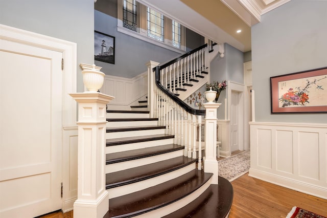 1860 Central Ave, Memphis, TN 38104 - stairs with a decorative wall, ornamental molding, a wainscoted wall, and wood finished floors