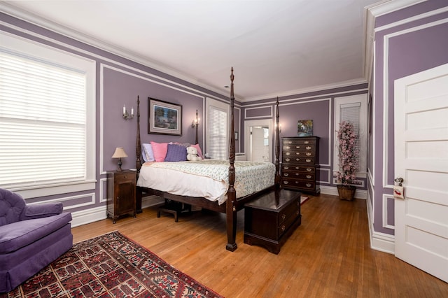 1860 Central Ave, Memphis, TN 38104 - bedroom featuring light wood finished floors, a decorative wall, and crown molding