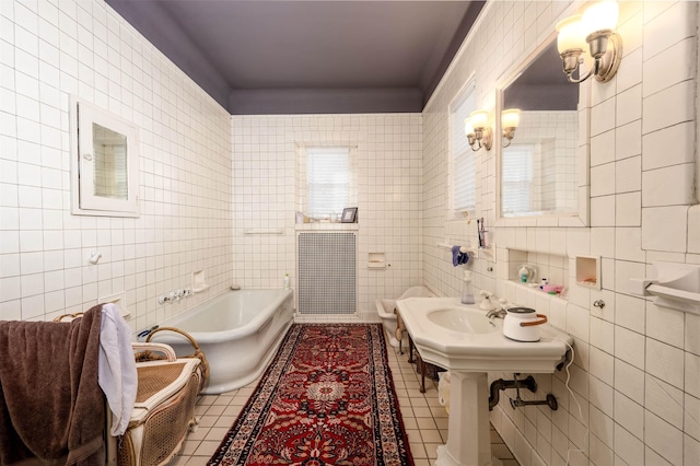 1860 Central Ave, Memphis, TN 38104 - full bath featuring tile patterned flooring, tile walls, a bathtub, and a sink