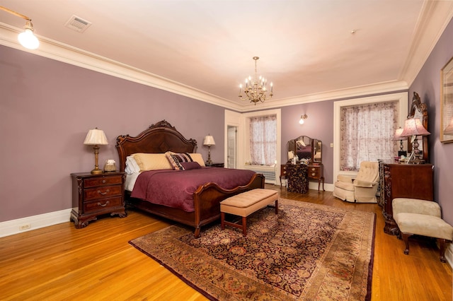 1860 Central Ave, Memphis, TN 38104 - bedroom featuring a chandelier, visible vents, light wood finished floors, and crown molding