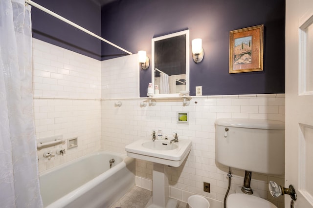 1860 Central Ave, Memphis, TN 38104 - full bath featuring shower / bath combo, a sink, wainscoting, tile walls, and toilet