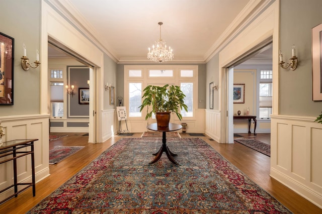 1860 Central Ave, Memphis, TN 38104 - foyer entrance with an inviting chandelier, wood finished floors, and ornamental molding