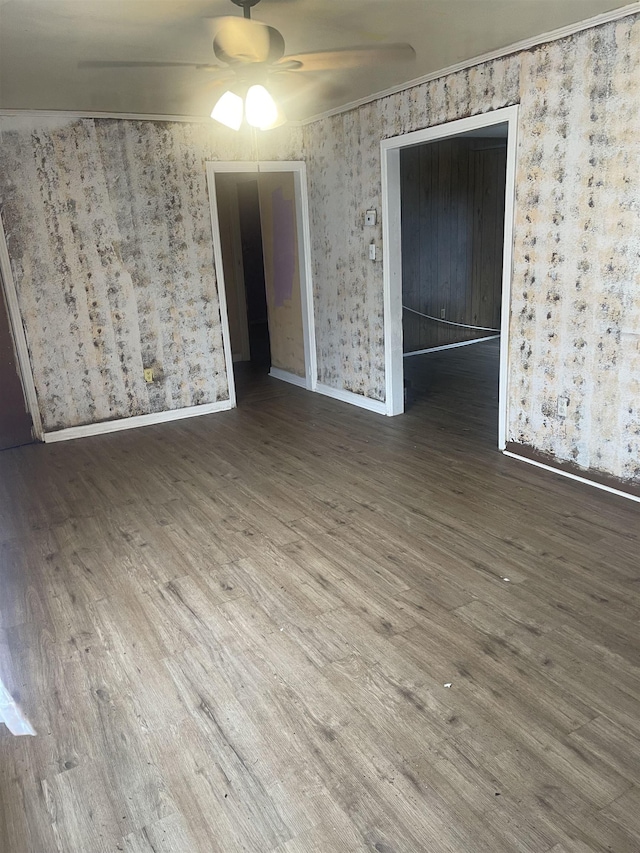 unfurnished room featuring baseboards, ceiling fan, and wood finished floors