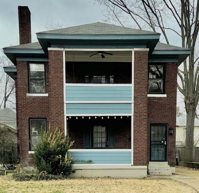 back of house with brick siding and a chimney