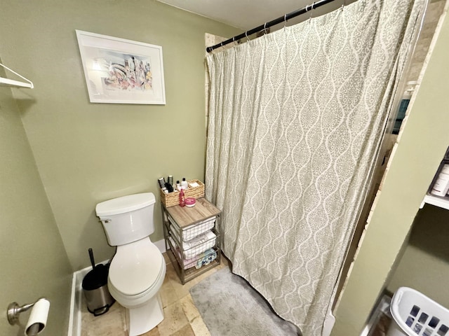 bathroom featuring toilet and a shower with curtain