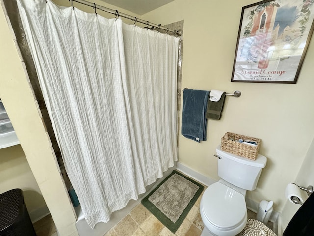 full bathroom with a shower with shower curtain, toilet, and baseboards