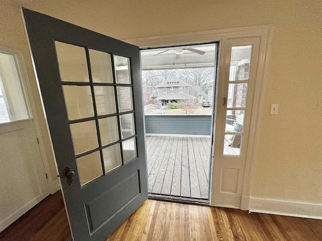 entryway with a ceiling fan, baseboards, and wood finished floors