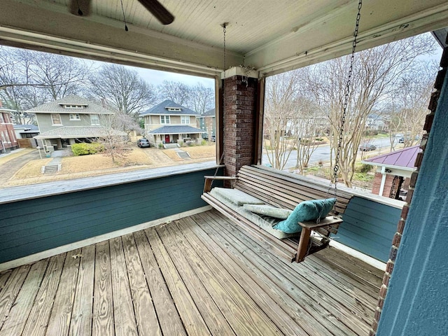 deck with covered porch and a residential view