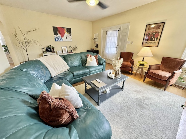 living area with ceiling fan and wood finished floors