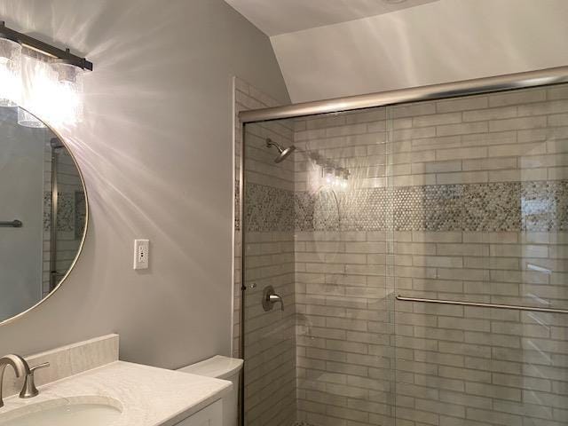 bathroom with a stall shower and vanity