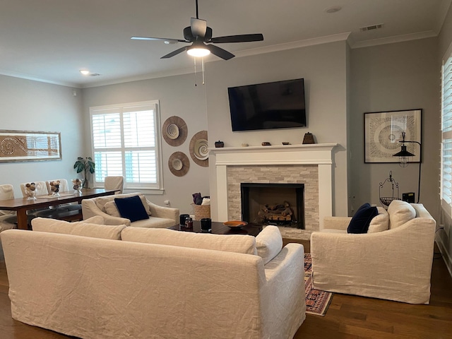 living room featuring visible vents, a ceiling fan, dark wood-style flooring, and crown molding