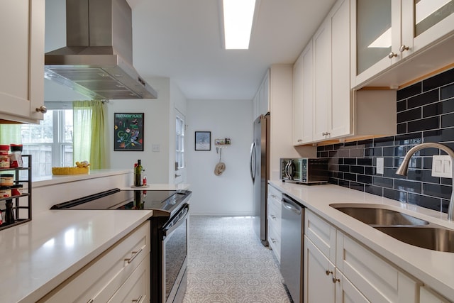 kitchen featuring a sink, appliances with stainless steel finishes, exhaust hood, white cabinets, and light countertops