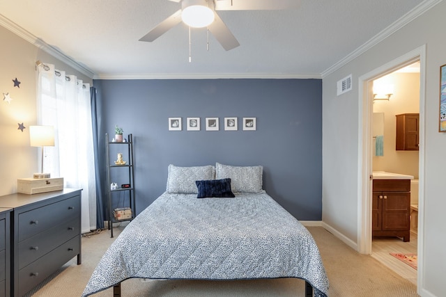 bedroom featuring baseboards, visible vents, ornamental molding, light colored carpet, and connected bathroom