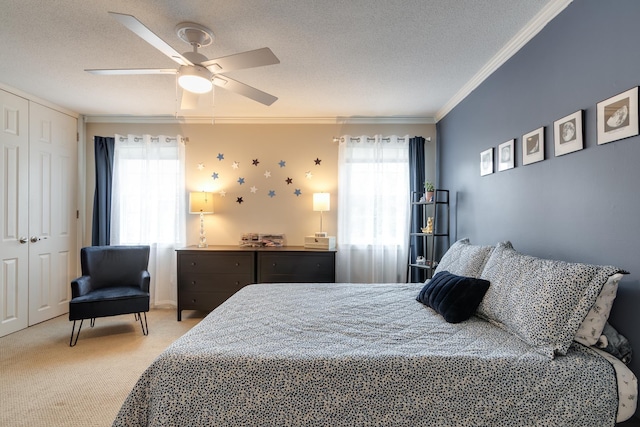 bedroom featuring multiple windows, a textured ceiling, light colored carpet, and ornamental molding