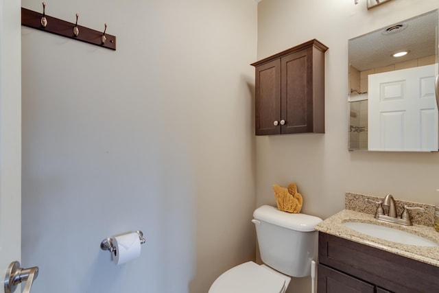 bathroom with toilet and vanity