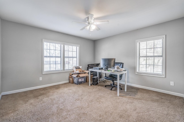 carpeted home office with baseboards and ceiling fan